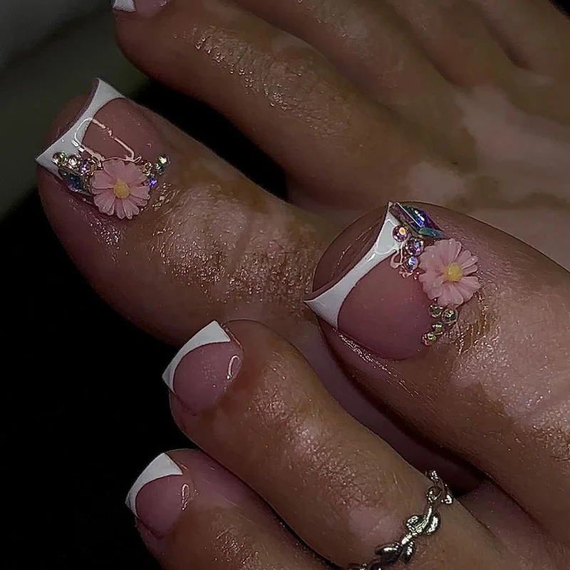 Kunstvolle Fußnagelkunst mit floralen Verzierungen Karnz