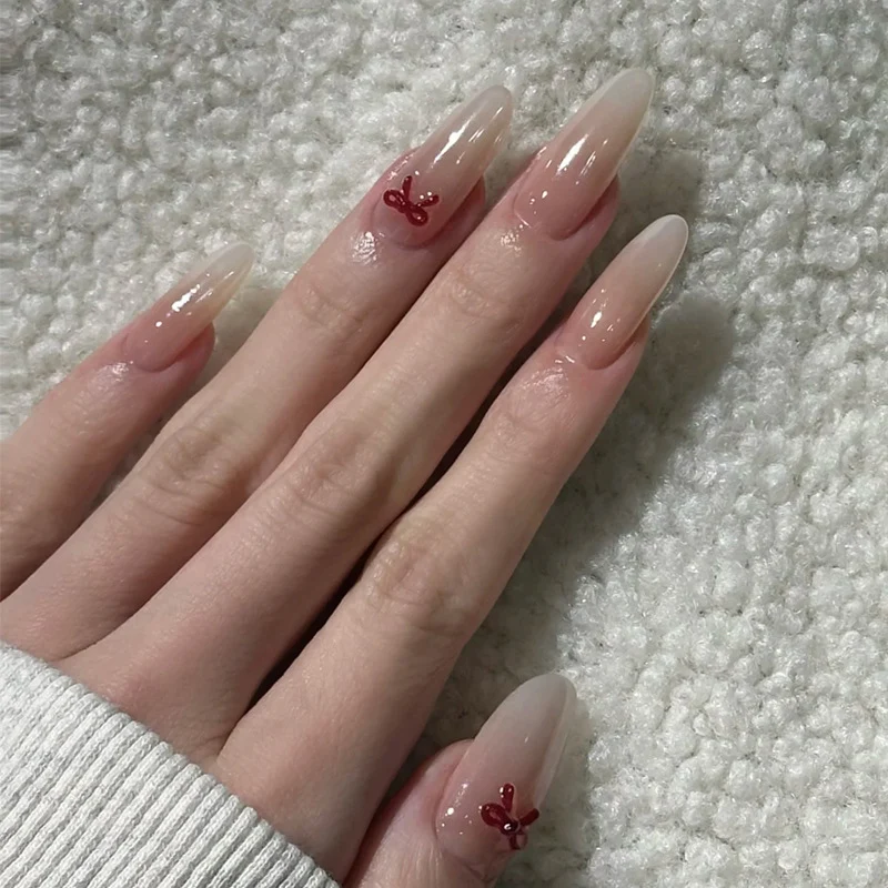 Elegante Stiletto Press-On Nägel mit dekorativen Schleifenakzenten Karnz