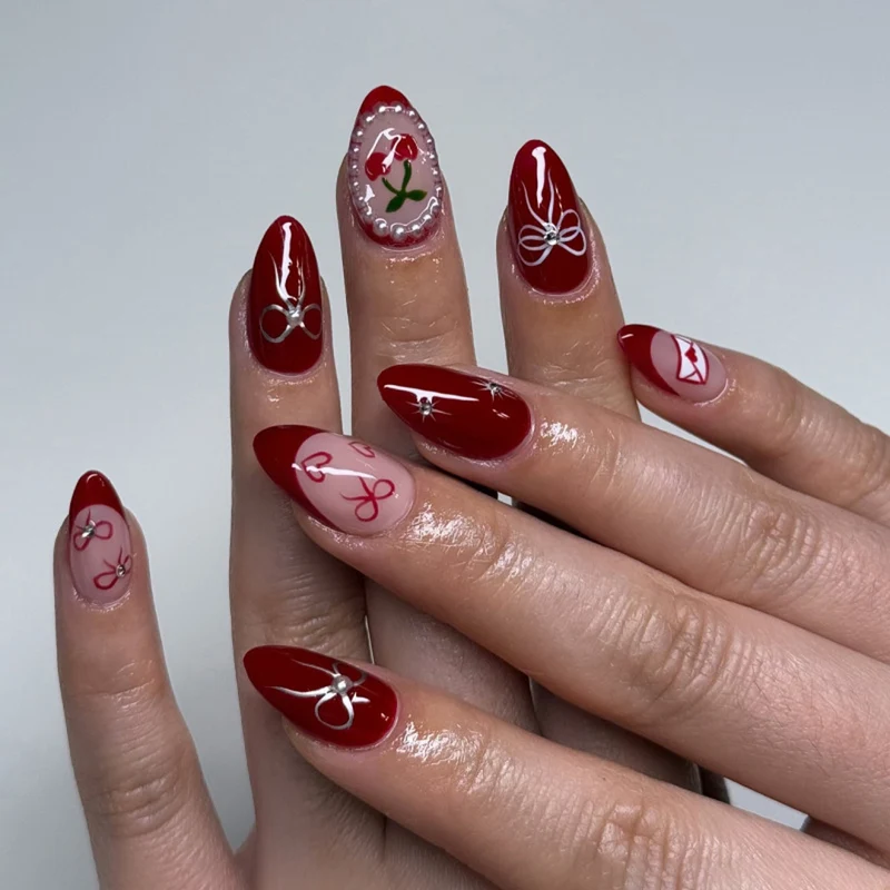 Kunstvolle Nageldesigns mit Schleifen- und Rosenmotiv Karnz