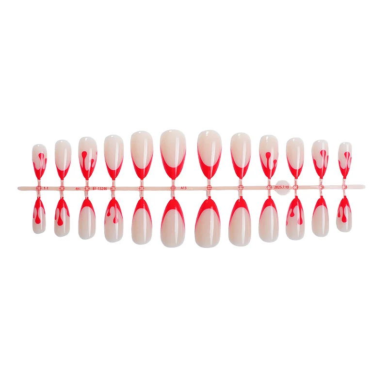 Kunstnagelset mit kreativem Rot-weißem Lackdesign Karnz